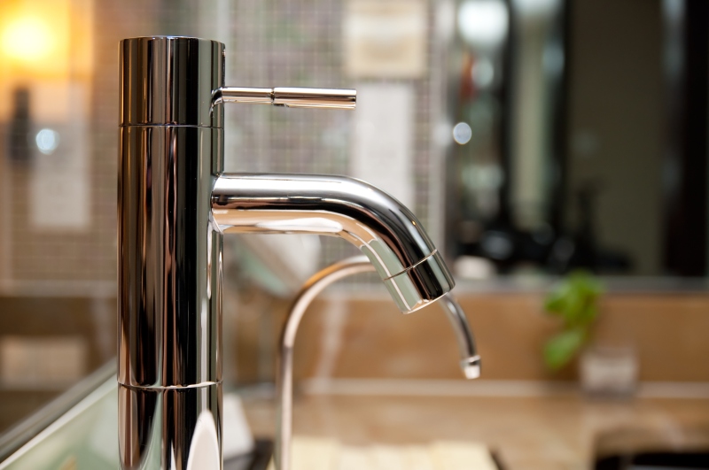 Leaking tap being repaired in Feltham